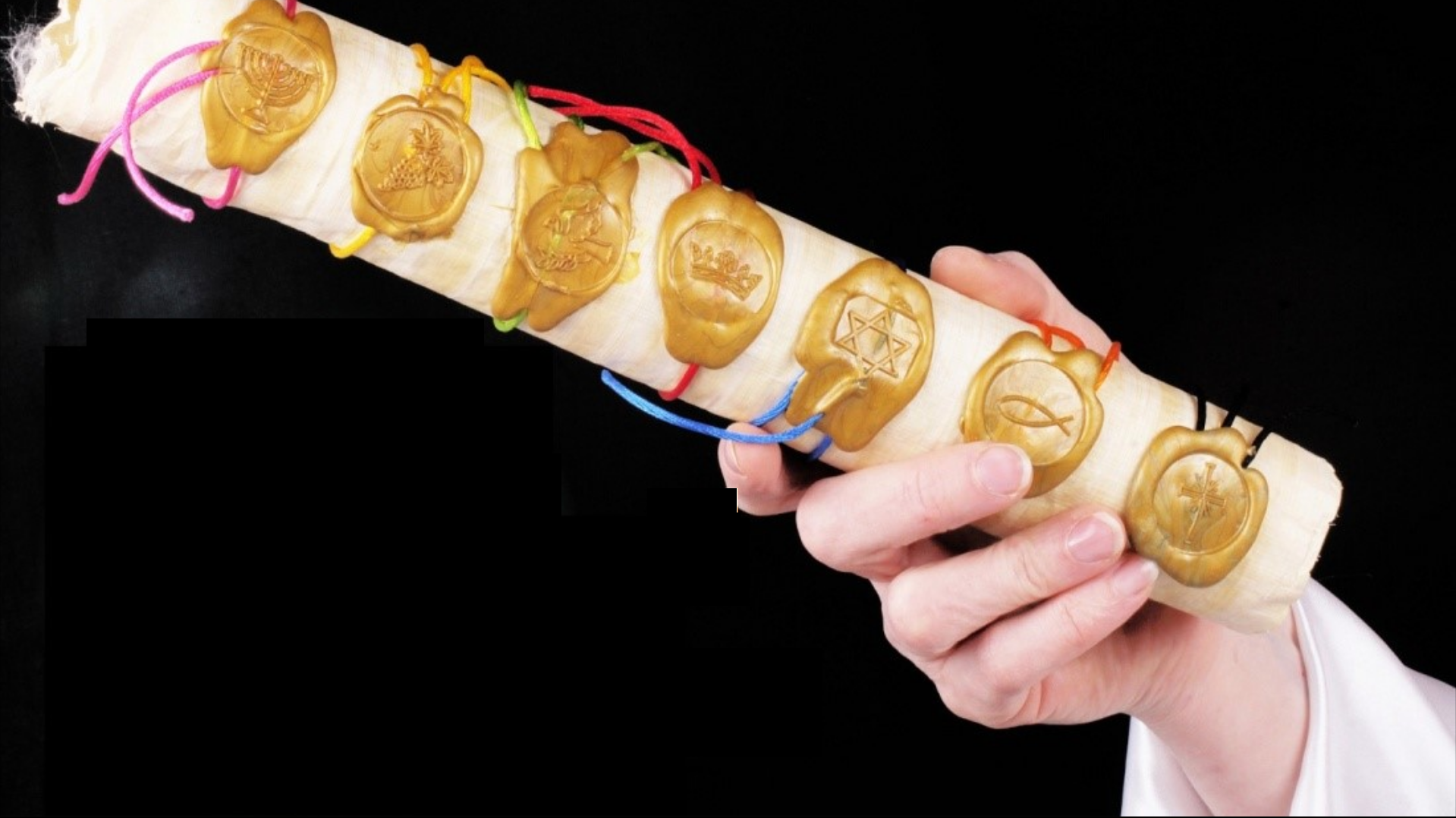 A picture of a rolled up scroll with 7 wax seals alomg its edge